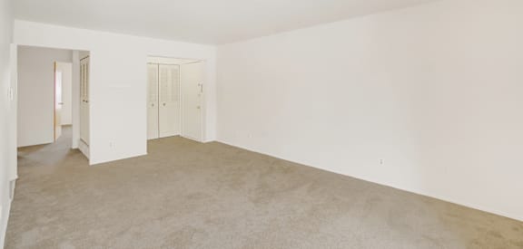 a bedroom with a carpeted floor and white walls