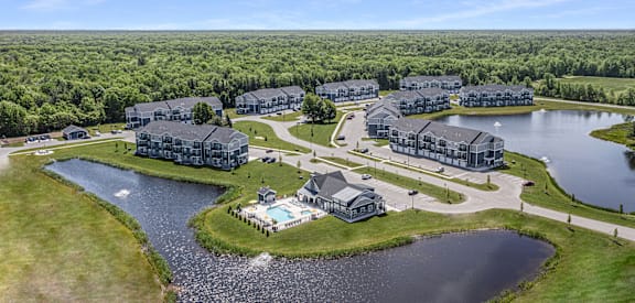 A bird's eye view of a resort with a large lake and buildings.