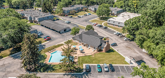 A bird's eye view of a residential complex with a swimming pool.