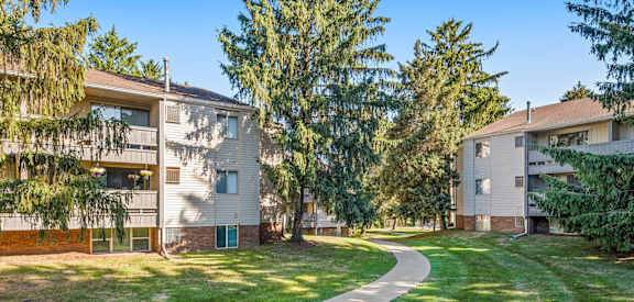 A sunny day at a residential area with apartment buildings and a green lawn.