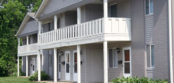 a gray house with a white porch