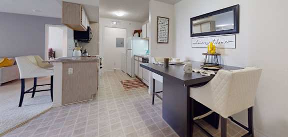 a kitchen and dining room with a table and chairs