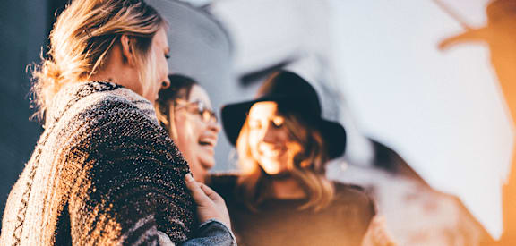 a group of women standing next to each other