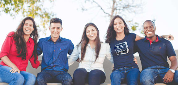 a group of people sitting on a wall