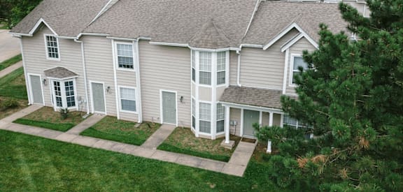 A large house with a grey roof and white trim.