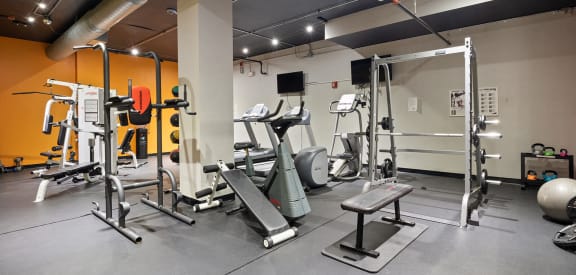 a gym with weights and cardio equipment in an apartment building