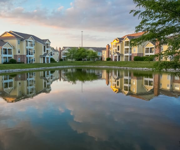 View of pond and building exteriors at Center Point Apartments, 6710 West Hollow Run Dr., 46214