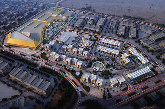 An aerial view of a city with a large building with a yellow and white roof.