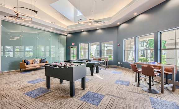 a game room with a foosball table and a pool table