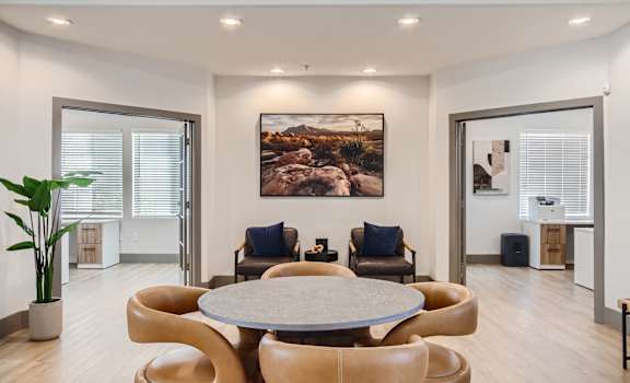 a living room with a round table and chairs