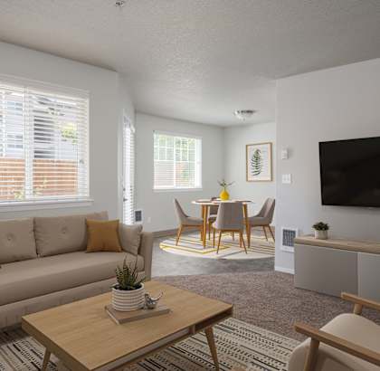 A living room with a couch, chairs, and a television.