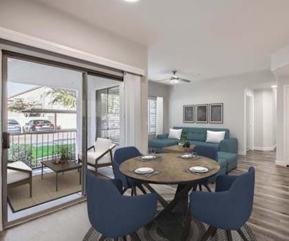 a living room and dining room with a table and chairs