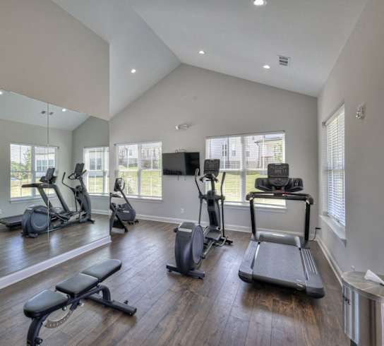 Large fitness center with mirror at 1104 Residences homes for rent in Antioch, TN.