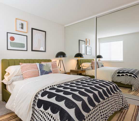 Bedroom with two beds and a large mirror at Brookside 112, Vancouver, WA