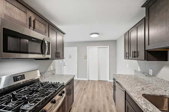 the preserve at ballantyne commons apartment kitchen with stove and microwave