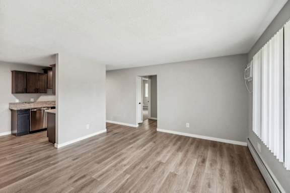 the living room and kitchen of an apartment with wood flooring