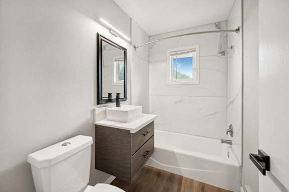 a bathroom with a toilet sink and shower