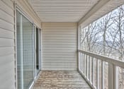 Thumbnail 20 of 28 - A balcony with a glass door and a wooden floor at Landmark at Lyncrest Reserve Apartments, Nashville, TN, 37209