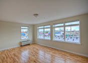 Thumbnail 2 of 6 - Living room with several windows and AC unit attached to the wall