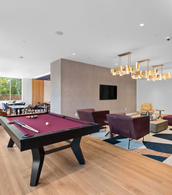 a spacious living room with a pool table and couchesat Hamilton at Eagleview, Exton Pennsylvania
