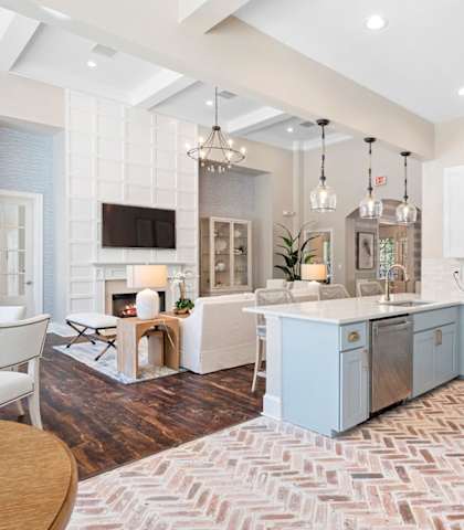 a kitchen and living room with blue cabinets and a rug at Sweetgrass Landing, Mount Pleasant