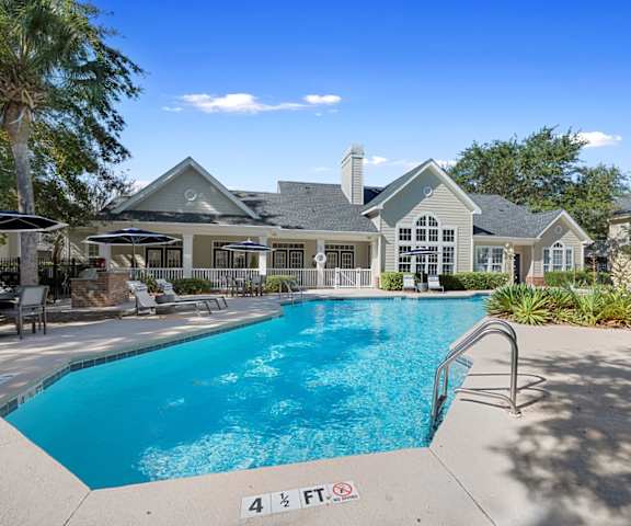 a swimming pool with a house in the background at Sweetgrass Landing, South Carolina, 29466