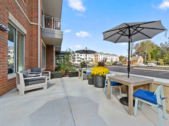 our apartments have a large patio with tables and chairs and umbrellas at Hamilton at Eagleview, Pennsylvania
