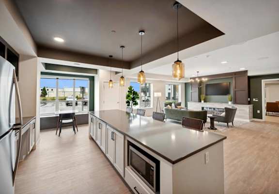 a large kitchen with a center island and a living room