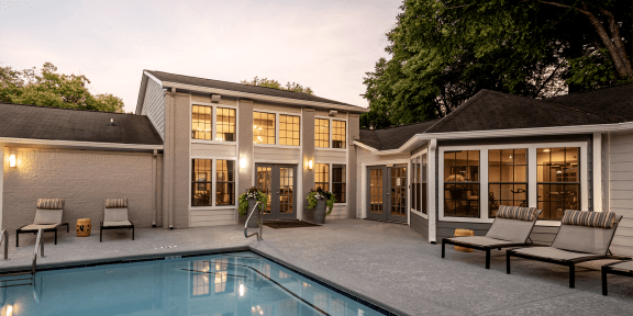 a house with a swimming pool in front of it