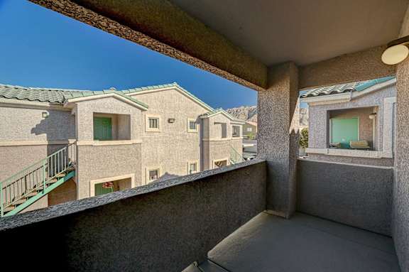 A balcony with a view of apartment buildings.