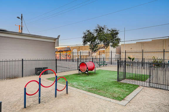 A playground with a red ball and a green bench.