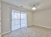 Thumbnail 18 of 28 - A room with a sliding glass door leading outside at Landmark at Lyncrest Reserve Apartments, Nashville, TN, 37209