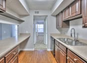 Thumbnail 5 of 28 - A kitchen with wooden cabinets and a sink. at Landmark at Lyncrest Reserve Apartments, Nashville, TN, 37209