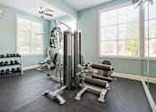 Thumbnail 3 of 7 - A gym with a variety of equipment including a leg press machine.