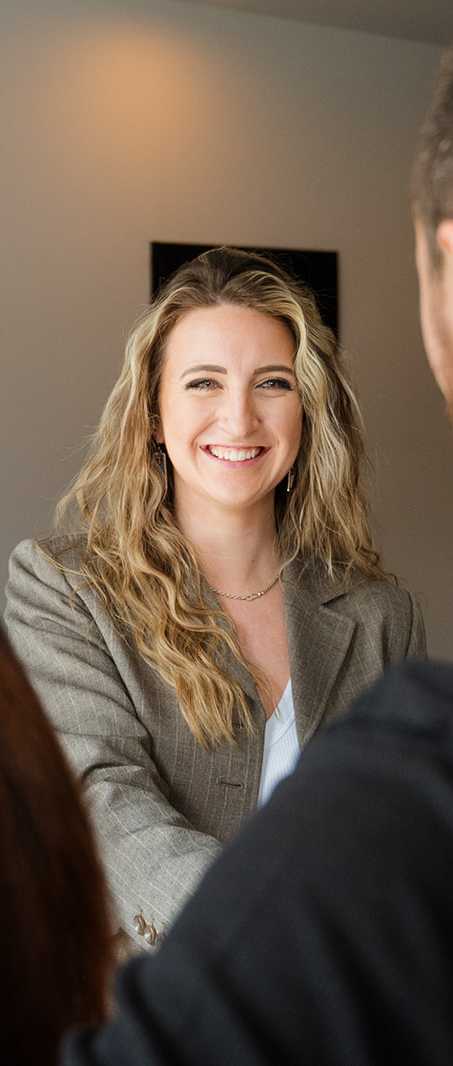 A woman with blonde hair is smiling at a man in a black shirt.