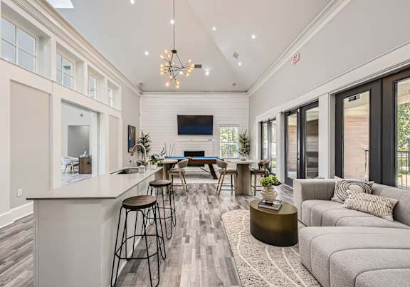 A modern living room with a bar area and a television.