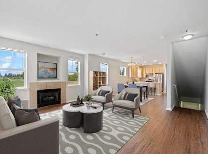 a living room with couches and chairs and a fireplace