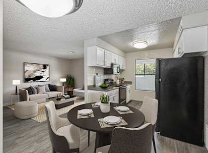 an open living room and kitchen with a table and chairs