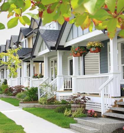 a row of white houses on a street