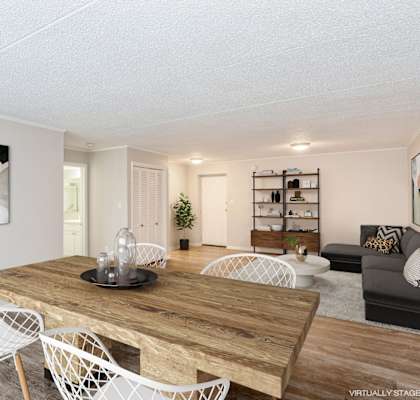 A living room with a wooden table and white chairs.