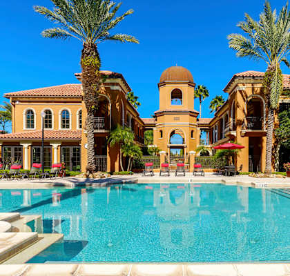 A large pool in front of a building with a dome and palm trees. at Madison Gateway, St. Petersburg, FL, 33716