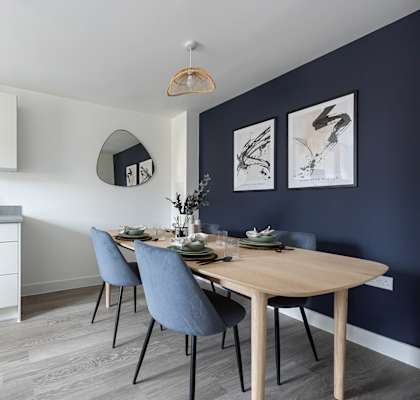 a kitchen and dining area with a table and chairs