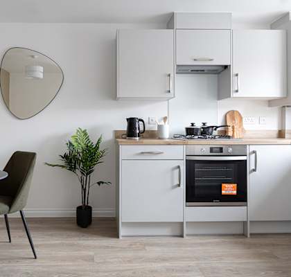 a kitchen with white cabinets and a table and chairs