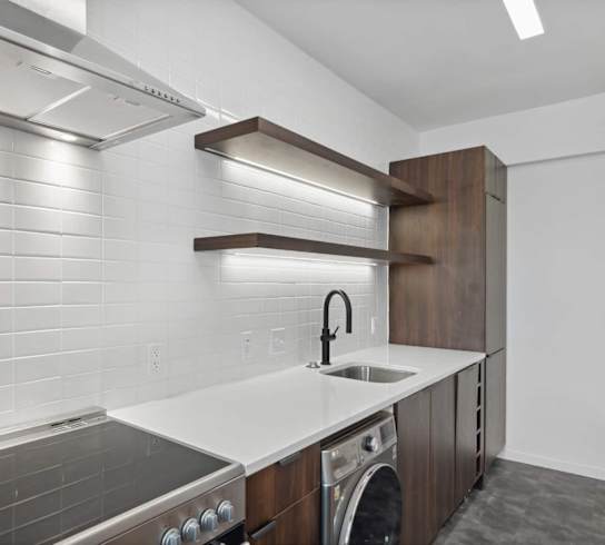 a kitchen with a stove top oven next to a sink