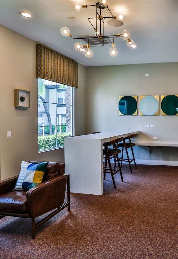 A room with a brown carpet and a brown leather chair.