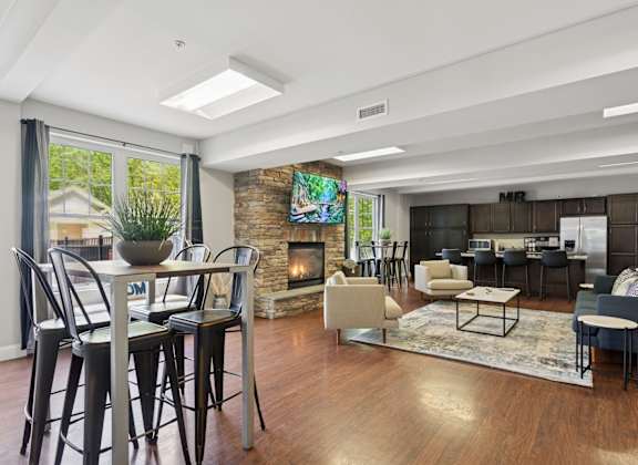 A modern living room with a fireplace and a dining table.