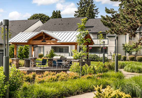 Patio with a table and chairs in the middle of a grassy area at Brookside 112, Vancouver, WA, 98682