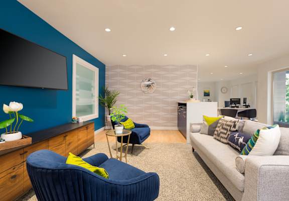 a living room with blue walls and a white and blue chevron accent wall