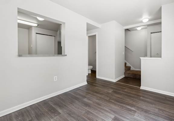 Living room with white walls and wood flooring at Mason Street Townhomes, Grand Rapids, Michigan