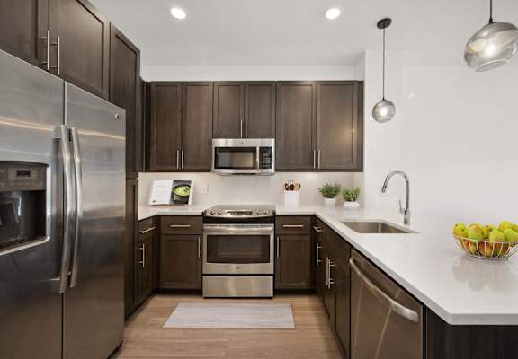 a kitchen with stainless steel appliances and wooden cabinets